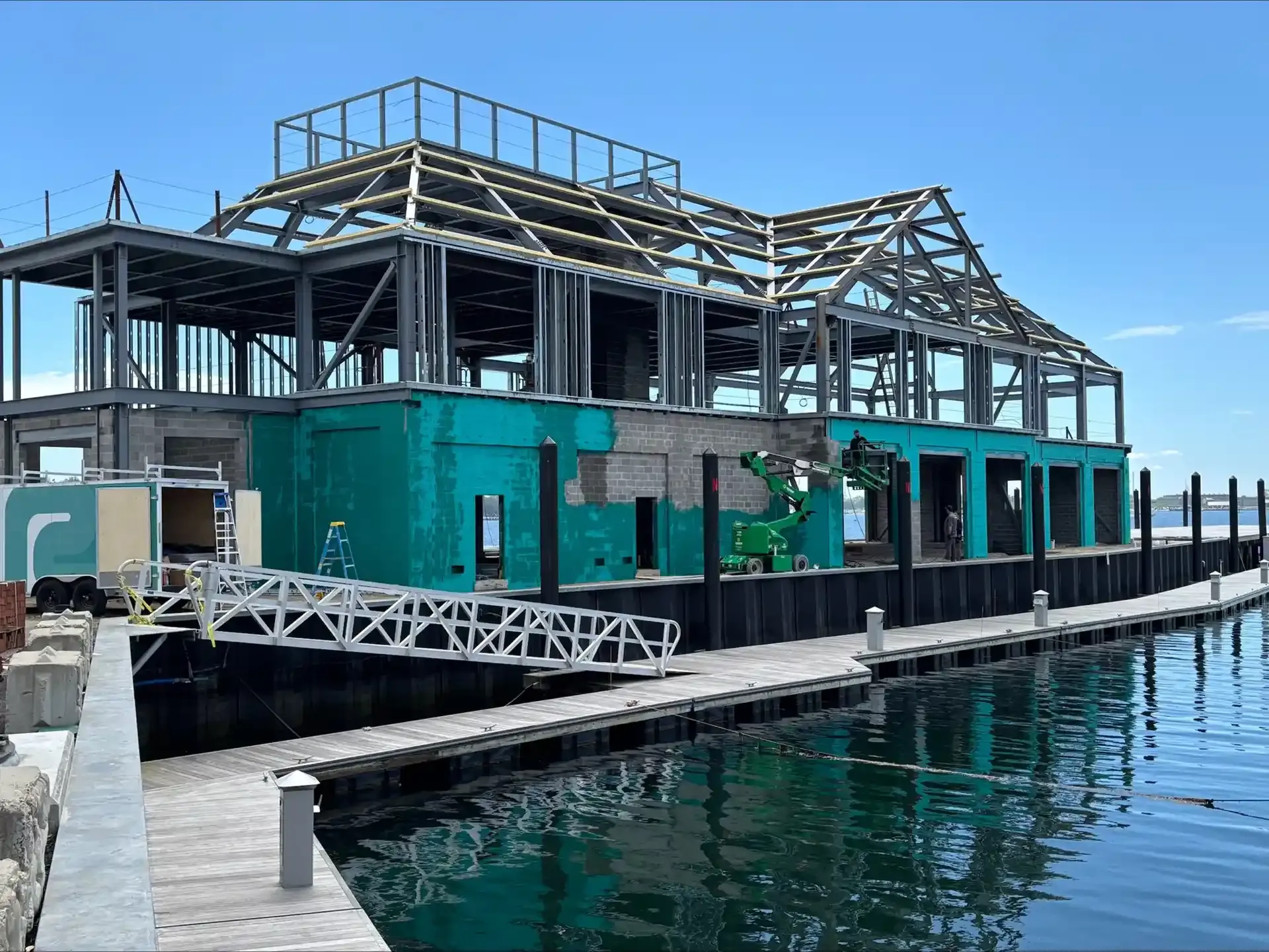 Waterfront commercial building with teal exterior waterproofing applied to the block walls