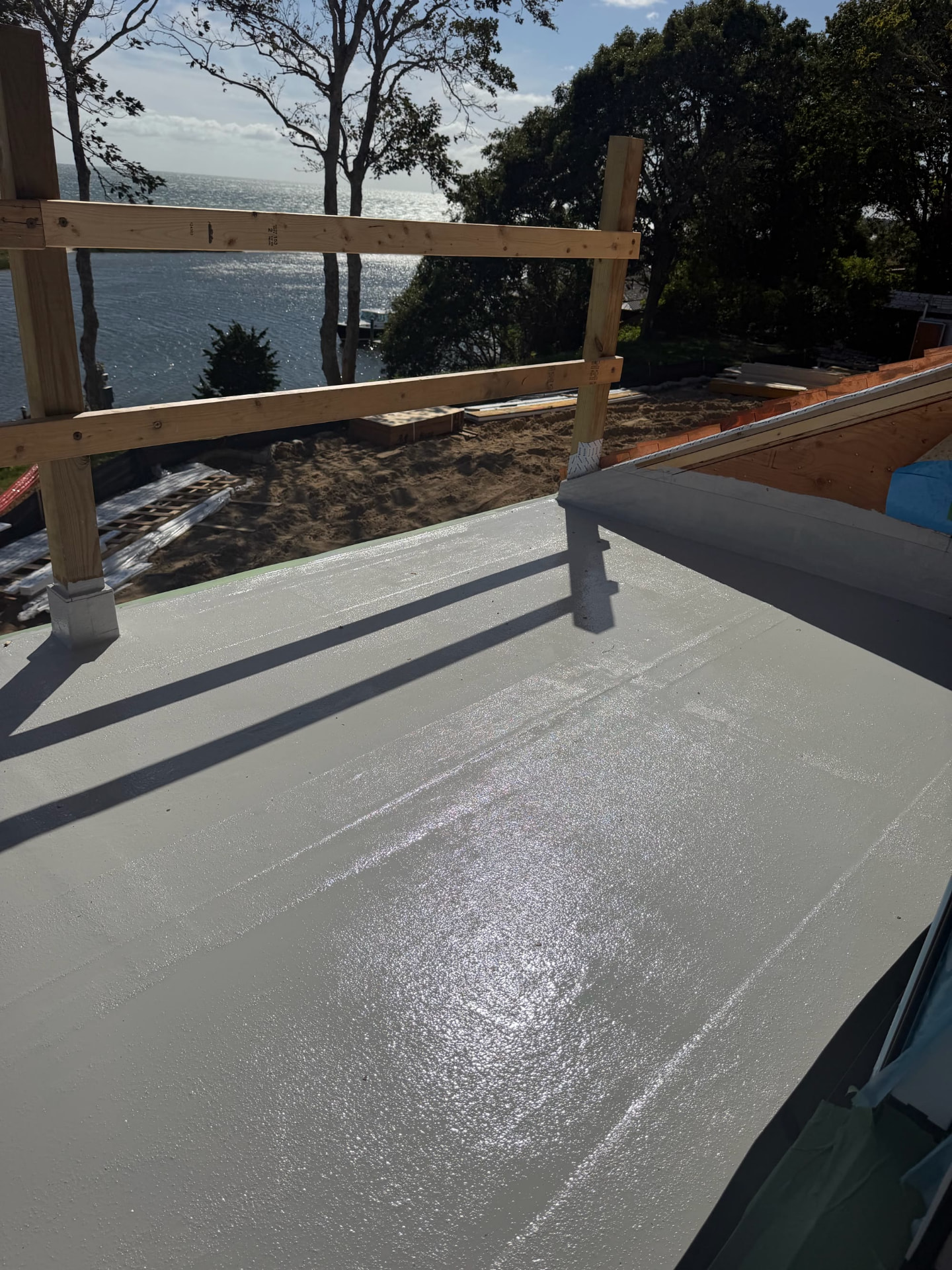 Finished liquid-applied waterproofing membrane on a waterfront deck