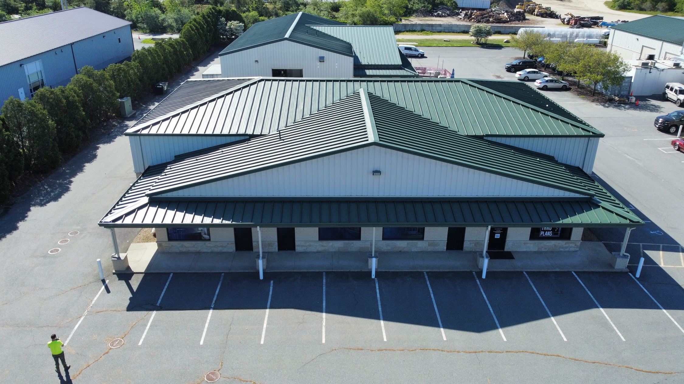 Aerial view of a metal roof restored with a fluid-applied coating system